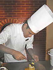 Aioli Restaurant Chef Saul Herrea finishing a dessert