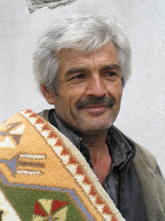 Turkish man with finished carpet