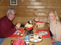 Edward and Debra share fondue at PrÃ¤tschli-Stall, Arosa, Switzerland 
