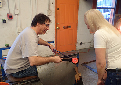 Rob Wolf, Debra Argen - shaping glass paperwieght - photo by Luxury Experience